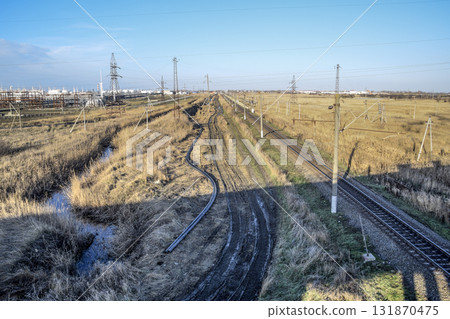Plot railway. Top view on the rails. High-voltage power lines for electric trains Plot railway. Top view on the rails. High-voltage power lines for electric trains 131870475