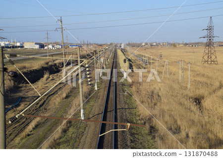 Plot railway. Top view on the rails. High-voltage power lines for electric trains Plot railway. Top view on the rails. High-voltage power lines for electric trains 131870488