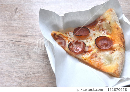 piece of baking homemade peperoni pizza topping slice salami on paper in plate piece of baking homemade peperoni pizza topping slice salami on paper in plate 131870658