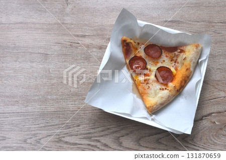 piece of baking homemade peperoni pizza topping slice salami on paper in plate piece of baking homemade peperoni pizza topping slice salami on paper in plate 131870659
