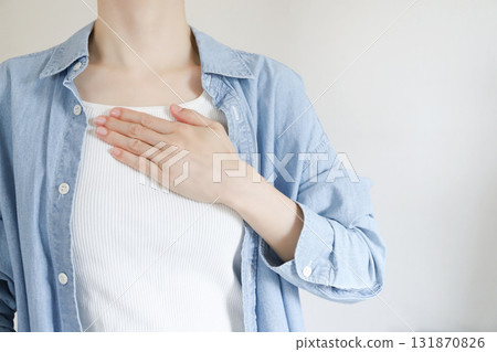 Woman with hand on chest worried Woman with hand on chest worried 131870826