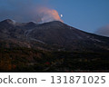Mt. Tokachi (Daisetsuzan, Hokkaido) emits smoke at dusk as the moon rises 131871025