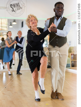 Senior woman and man dancing swing in studio 131871406
