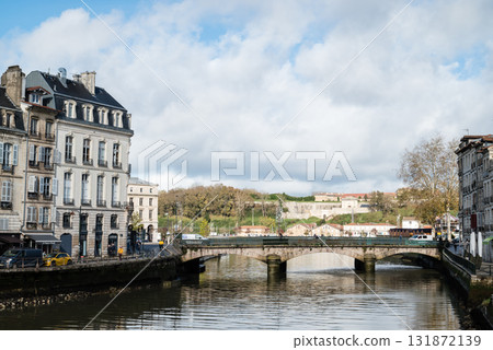 A streetscape of historic buildings along the river in Bayonne, in the heart of the French Basque Country A streetscape of historic buildings along the river in Bayonne, in the heart of the French Basque Country 131872139