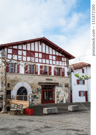Red and white buildings decorated with chili peppers in Espelette, a village famous for its chili peppers in the French Basque Country Red and white buildings decorated with chili peppers in Espelette, a village famous for its chili peppers in the French Basque Country 131872300