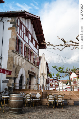 Red and white buildings decorated with chili peppers in Espelette, a village famous for its chili peppers in the French Basque Country Red and white buildings decorated with chili peppers in Espelette, a village famous for its chili peppers in the French Basque Country 131872302