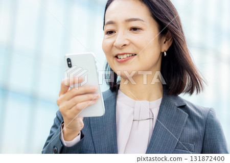 Business woman with a smartphone Business woman with a smartphone 131872400
