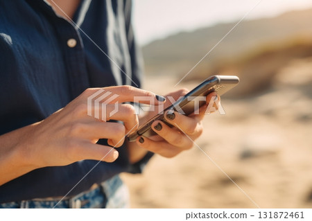 Female hands use phone close-up, macro. Woman with smartphone at sea beach resort. Sunset. Girl checking social media, texting with friends, surfing online, enjoys vacation. Typing message, news. Female hands use phone close-up, macro. Woman with smartphone at sea beach resort. Sunset. Girl checking social media, texting with friends, surfing online, enjoys vacation. Typing message, news. 131872461
