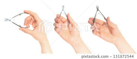 Set of hands holding cuticle nippers, isolated on transparent background Set of hands holding cuticle nippers, isolated on transparent background 131872544