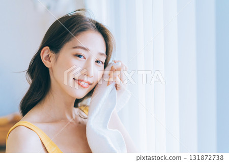 A woman wiping his face with a towel 131872738