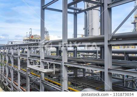 Large industrial building with a lot of pipes and a lot of yellow 131873034