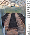 An empty greenhouse with prepared soil after harvesting. 131873059