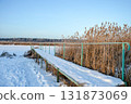 An old rustic wooden pier on Ivanovsky Bay in winter. Ulyanovsk. Russia 131873069