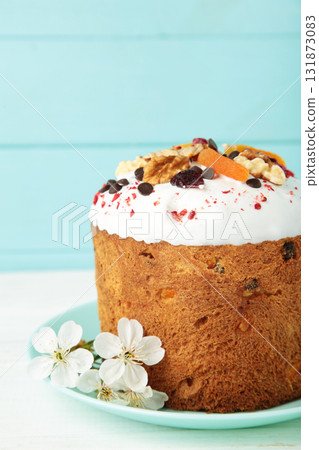 Traditional easter cakes with colorful sprinkles, with eggs and spring flowers on blue background. Traditional easter cakes with colorful sprinkles, with eggs and spring flowers on blue background. 131873083