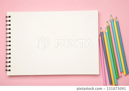 Sketchbook and colored pencils on pink background 131873091