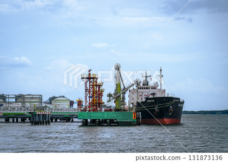 Large ship is docked at a pier 131873136