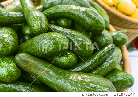 Basket of green avocados 131873147