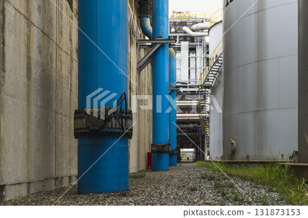 Blue pipe is in the middle of a row of blue pipes 131873153