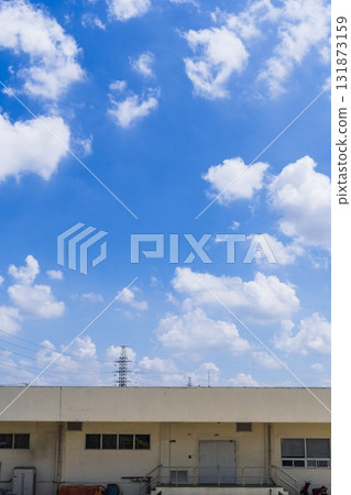 Building with a white roof and a blue sky in the background 131873159