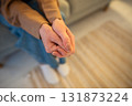 Anxious woman with crossed hands nervously fidgeting, waiting for therapy session in hospital alone 131873224