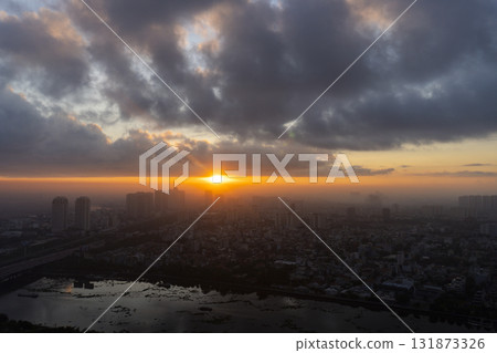 City skyline with a large sun in the sky City skyline with a large sun in the sky 131873326