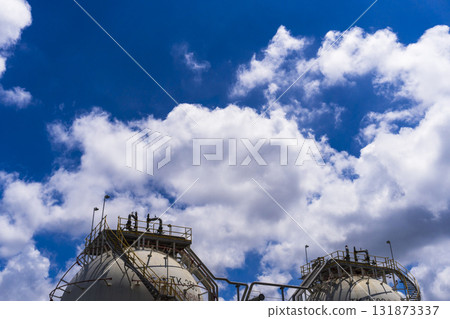 Two large tanks are on top of a building 131873337