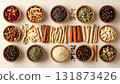 A neatly arranged flat lay of dried adaptogenic roots and herbs such as ashwagandha and rhodiola, displayed in small wooden bowls on a neutral background, symbolizing natural wellness and balance 131873426