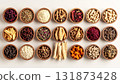 A neatly arranged flat lay of dried adaptogenic roots and herbs such as ashwagandha and rhodiola, displayed in small wooden bowls on a neutral background, symbolizing natural wellness and balance 131873428