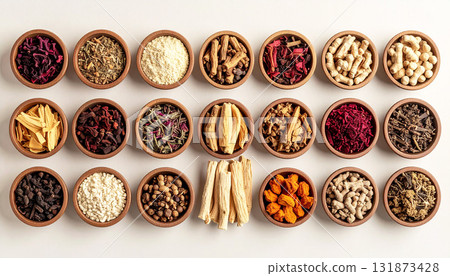 A neatly arranged flat lay of dried adaptogenic roots and herbs such as ashwagandha and rhodiola, displayed in small wooden bowls on a neutral background, symbolizing natural wellness and balance 131873428
