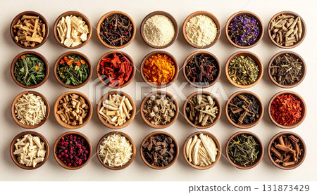 A neatly arranged flat lay of dried adaptogenic roots and herbs such as ashwagandha and rhodiola, displayed in small wooden bowls on a neutral background, symbolizing natural wellness and balance 131873429