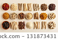 A neatly arranged flat lay of dried adaptogenic roots and herbs such as ashwagandha and rhodiola, displayed in small wooden bowls on a neutral background, symbolizing natural wellness and balance 131873431