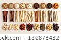 A neatly arranged flat lay of dried adaptogenic roots and herbs such as ashwagandha and rhodiola, displayed in small wooden bowls on a neutral background, symbolizing natural wellness and balance 131873432