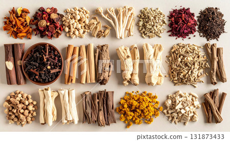 A neatly arranged flat lay of dried adaptogenic roots and herbs such as ashwagandha and rhodiola, displayed in small wooden bowls on a neutral background, symbolizing natural wellness and balance 131873433