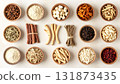 A neatly arranged flat lay of dried adaptogenic roots and herbs such as ashwagandha and rhodiola, displayed in small wooden bowls on a neutral background, symbolizing natural wellness and balance 131873435