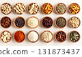 A neatly arranged flat lay of dried adaptogenic roots and herbs such as ashwagandha and rhodiola, displayed in small wooden bowls on a neutral background, symbolizing natural wellness and balance 131873437