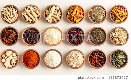 A neatly arranged flat lay of dried adaptogenic roots and herbs such as ashwagandha and rhodiola, displayed in small wooden bowls on a neutral background, symbolizing natural wellness and balance 131873437