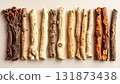 A neatly arranged flat lay of dried adaptogenic roots and herbs such as ashwagandha and rhodiola, displayed in small wooden bowls on a neutral background, symbolizing natural wellness and balance 131873438