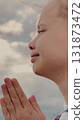 Hopeful Child with Closed Eyes, Innocent Prayer Gesture, Little Girl Asking for Guidance, Connected to Nature in Prayer, Pure Heart of a Child, Prayer Beyond Words, Child Facing the Sky, Sincere 131873472