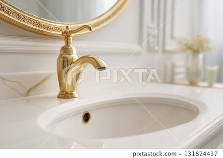 Modern golden faucet and marble stone sink. Stylish white sink, faucets in a light interior. Copper brass tap. Domestic Appliances. Clean bright bathroom. Household equipment. New Contemporary style Modern golden faucet and marble stone sink. Stylish white sink, faucets in a light interior. Copper brass tap. Domestic Appliances. Clean bright bathroom. Household equipment. New Contemporary style 131874437