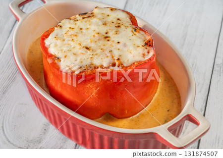 Colorful bell peppers baked with bolognese sauce and golden melted mozzarella topping Colorful bell peppers baked with bolognese sauce and golden melted mozzarella topping 131874507