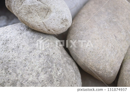 Close-up of rough stone texture. Natural gray stones close-up. Granite stones. 131874937