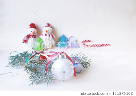 A cozy winter holiday scene with snowmen and Christmas decorations. Festive Christmas decorations. 131875108