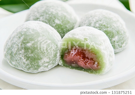 Delicious Japanese moti desserts. Close up. Asian rice daifuku dessert sweet mochi. Cut in half with filling. Traditional dessert mochi ice cream. Colorful rice cake. Fukashi manju. Culinary delights 131875251