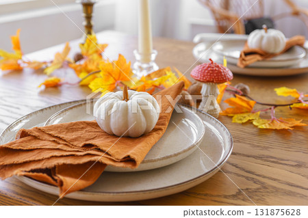 Autumn, fall, Halloween or thanksgiving festive day table setting with yellow leaves and pumpkins 131875628