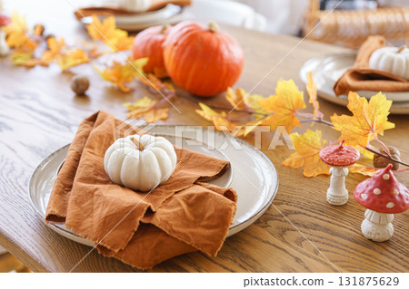 Autumn, fall, Halloween or Thanksgiving festive day table setting with yellow leaves and pumpkins Autumn, fall, Halloween or Thanksgiving festive day table setting with yellow leaves and pumpkins 131875629