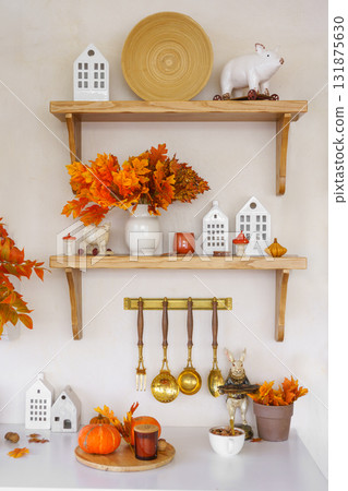 Kitchen autumn decor with pumpkins, kitchen utensils, and vibrant foliage in bright space 131875630