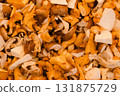 Fresh mushrooms including chanterelles and porcini arranged in a pile, symbolizing forest harvest 131875729