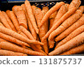 Fresh orange carrots arranged in a pile at a market stall, symbolizing organic farming, healthy 131875737