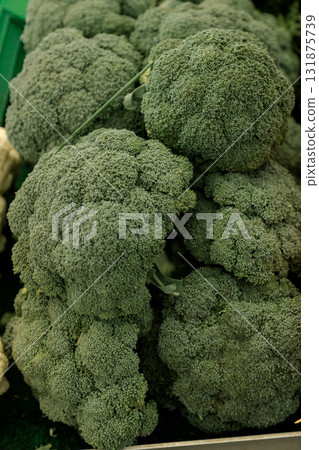 Fresh green broccoli heads piled together at a market stall, symbolizing organic farming, plant Fresh green broccoli heads piled together at a market stall, symbolizing organic farming, plant 131875739