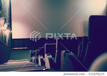 Empty cinema with white screen and seats. Side view 131876223